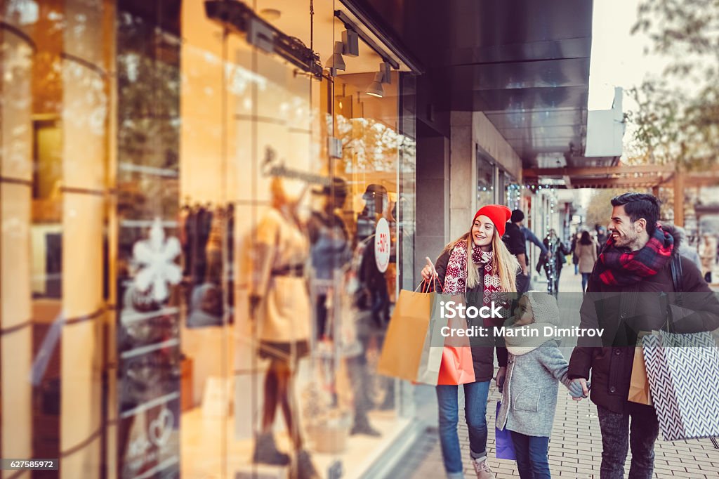 Young family shopping for Christmas Family with one kid enjoying a Christmas shopping Shopping Stock Photo
