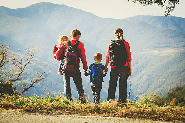 istock family with two kids hiking in mountains 627586708