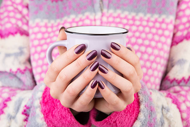 istock Woman in cozy sweater holding a cup 627587334