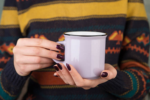 istock Woman in cozy sweater holding a cup 627587414