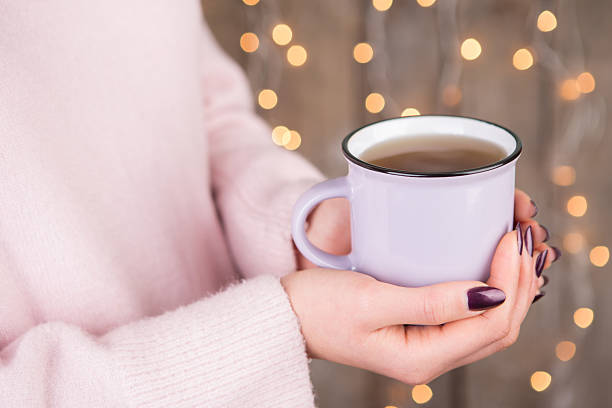 istock Woman in cozy sweater holding a cup 627625464