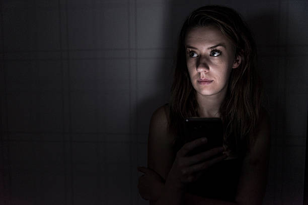 istock Lonely Woman using smartphone at night 627625590