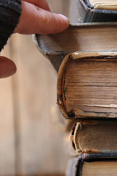 istock student or scientist takes the book on a shelf in 627626440