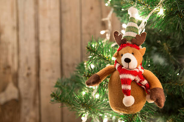 istock Christmas tree with lights on the wooden background 627627648