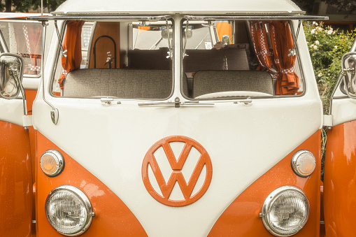 Jüchen, Germany - August 5, 2016: 1950s Volkswagen Transporter T1 campervans with open doors parked in a park. The Volkswagen Transporter is a popular van to use as a camper and was delivered originally as a camper van, but many have been converted later. The car is on display during the 2016 Classic Days at castle Dyck. 