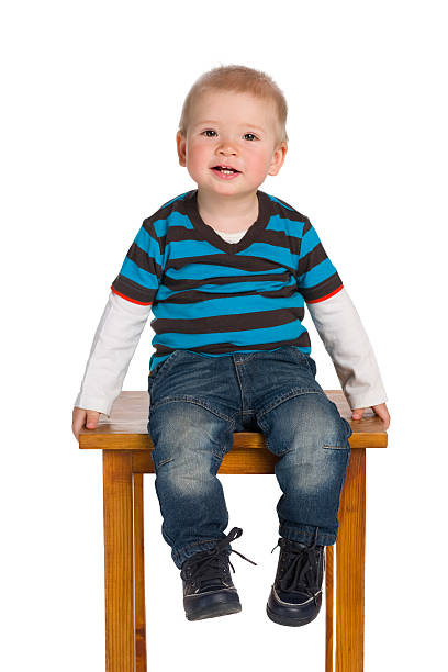 istock Cute little boy sits on the chair 627628592