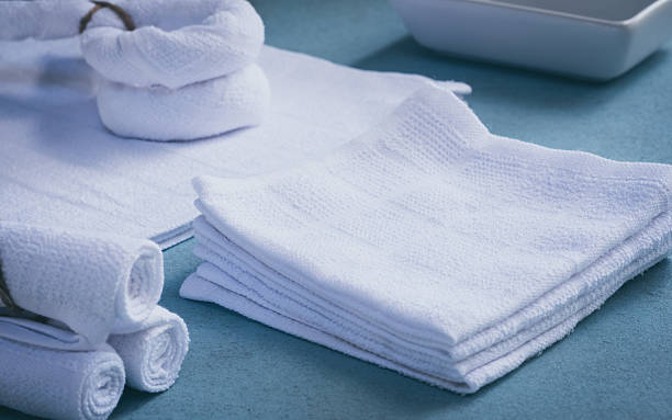 istock Rolled up white spa towels, selective focus, vintage 627628984