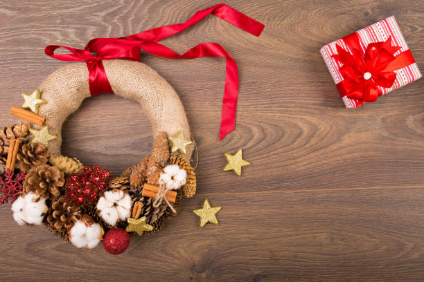 istock Christmas wreath and decor on a wooden background 627645754