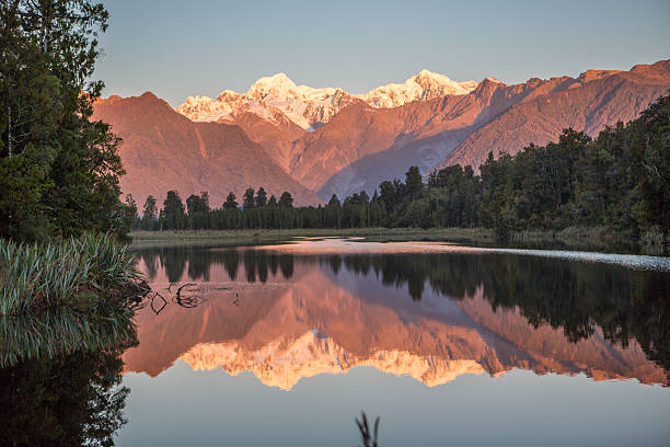 istock Scenic View Of Trees And Mountains Reflection In Lake Matheson 627646092