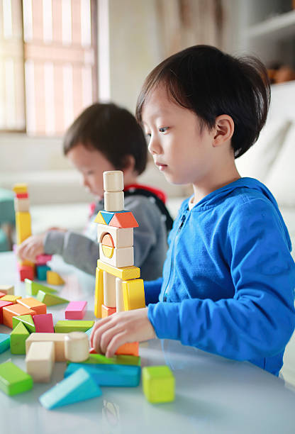 istock Cute asian Children playing with blocks 627660468