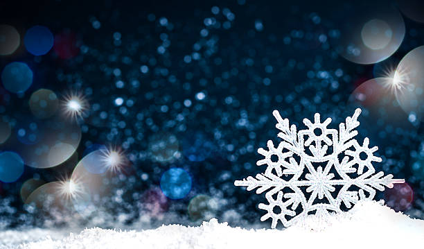 istock Snowflake in the snow on a dark blue background 627661118