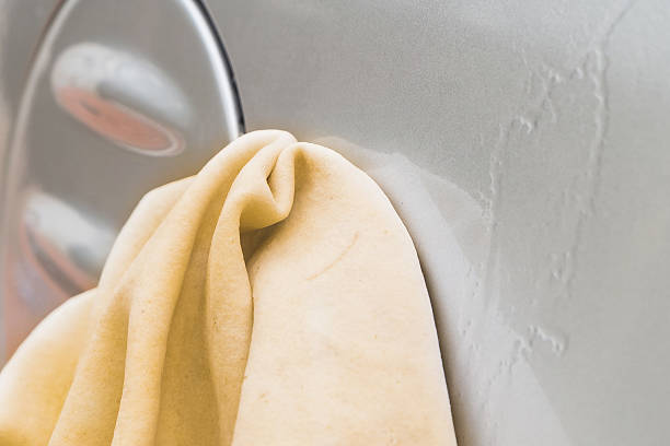 male hand washing car with yellow chamois (microfiber towel) - male beauty imagens e fotografias de stock