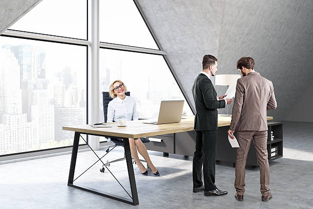 istock Woman sitting and men talking in a CEO office 627667492