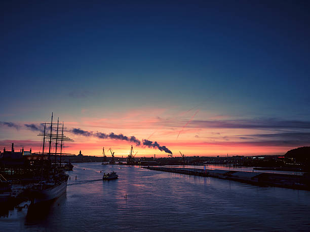 Sun setting over Gothenburg city harbor in Sweden. Shot on a beautiful autumn evening.