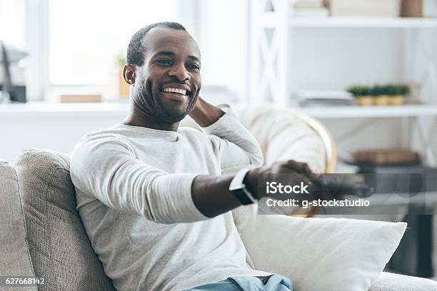 Watching Tv At Home Stock Photo - Download Image Now - Watching TV, Remote Control, Men