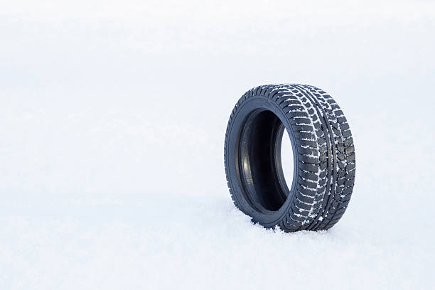 istock Black rubber tire rolling on the soft, fresh snow. 627668290