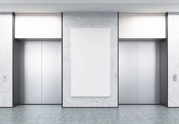 istock Two closed elevators in corridor with concrete walls and poster 627669336