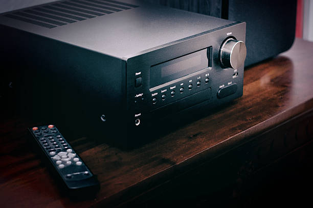 istock Black receiver and remote on wooden desk 627669722