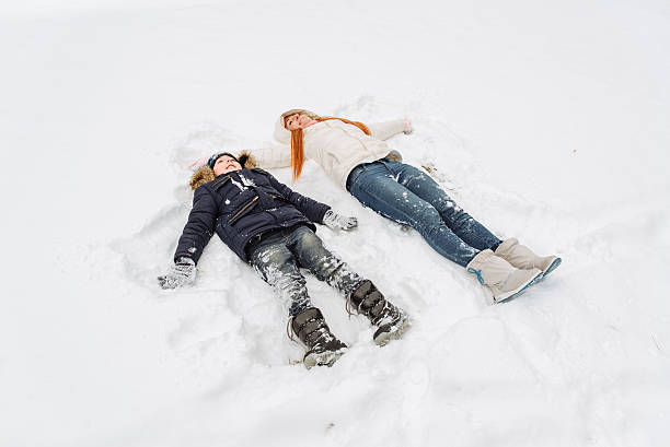 istock mother and son having fun in the snow winter day 627670002