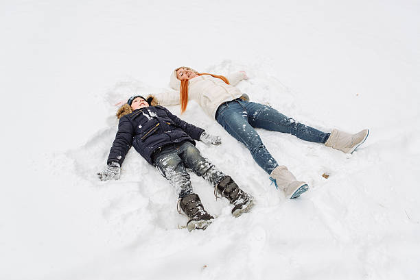 istock mother and son having fun in the snow winter day 627670082