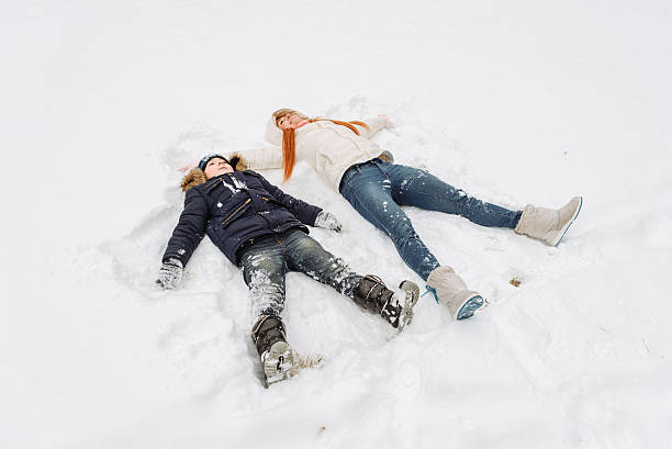 istock mother and son having fun in the snow  winter day 627670174