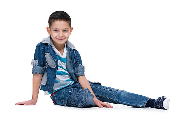 istock Handsome little boy sits on the white background 627671056