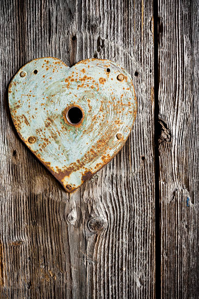 istock Trim on keyhole as heart on old wood. Vertical shot. 627672424