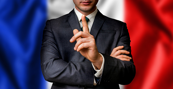 French candidate speaks to the people crowd with one finger on lips - election in France