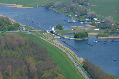 Roggebot bridge connecting Flevoland to Overijssel in The Netherlands. Boats are leaving the locks while there is a traffic jam on the road.