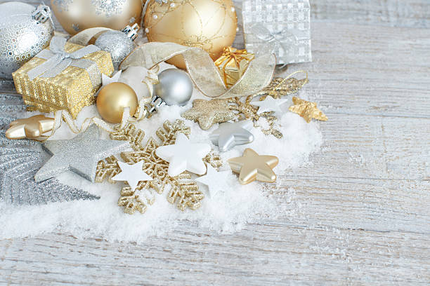 Silver and golden Christmas decorations ans gift boxes close up
