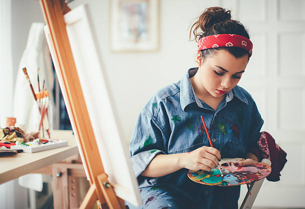 istock Young girl paints on canvas 627677830