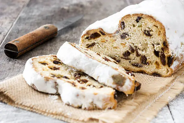 Christmas stollen. Traditional german Christmas dessert on wooden background
