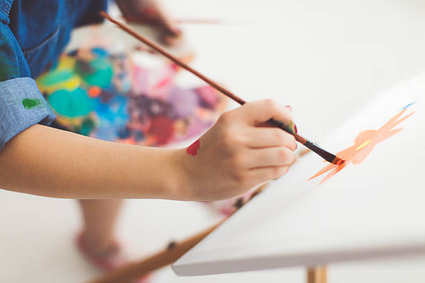 istock Young girl paints on canvas 627679122
