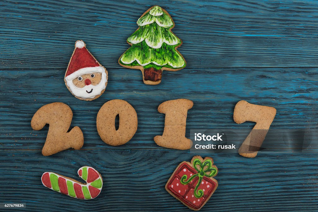 Gingerbreads for new 2017 years Gingerbreads for new 2017 year holiday on wooden background, xmas theme 2017 Stock Photo