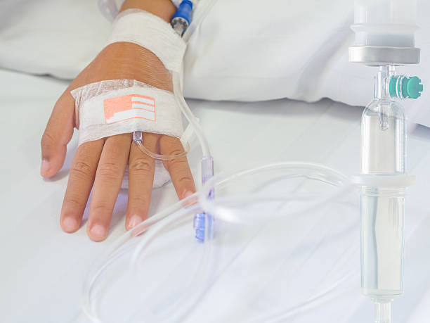 saline intravenous (iv) drip on children hand in hospital. - iv pump imagens e fotografias de stock