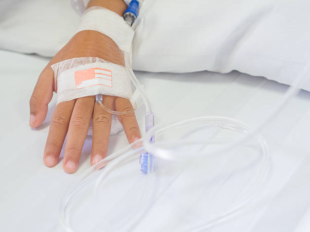 saline intravenous (iv) drip on children hand in hospital. - iv pump imagens e fotografias de stock