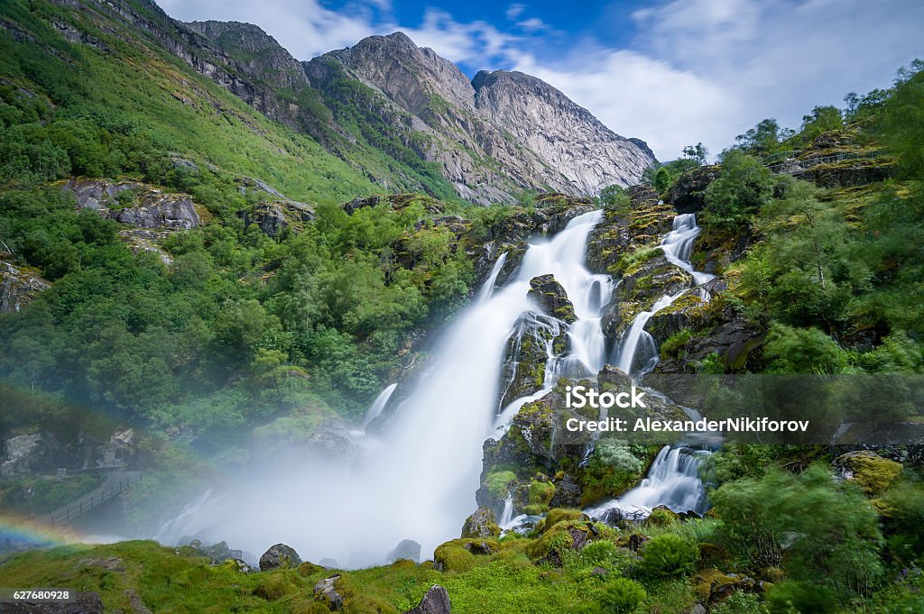 Briksdalsbreen national park waterfall long exposure Briksdalsbreen waterfall long exposure photo. Briksdal, Norway national park and popular hiking path to glacier viewpoint. Waterfall Stock Photo