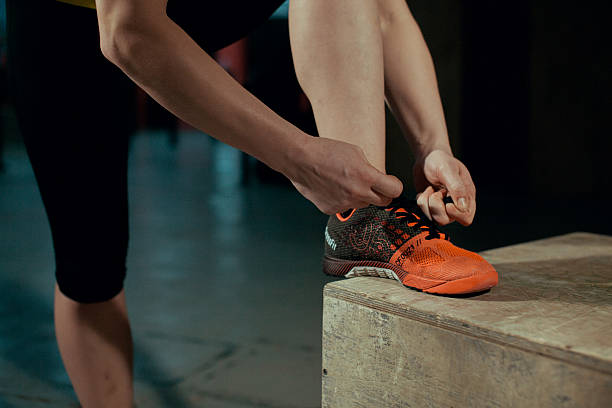 istock Woman tying shoelaces at gym. 627681104