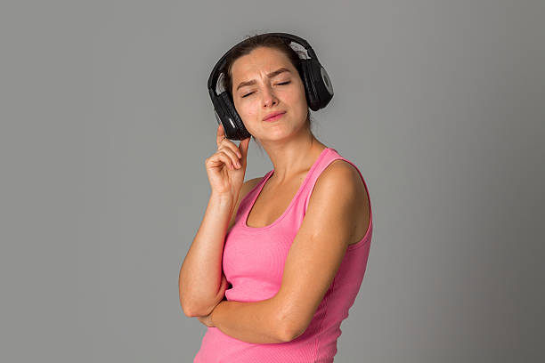 istock girl with headphones in studio 627719482