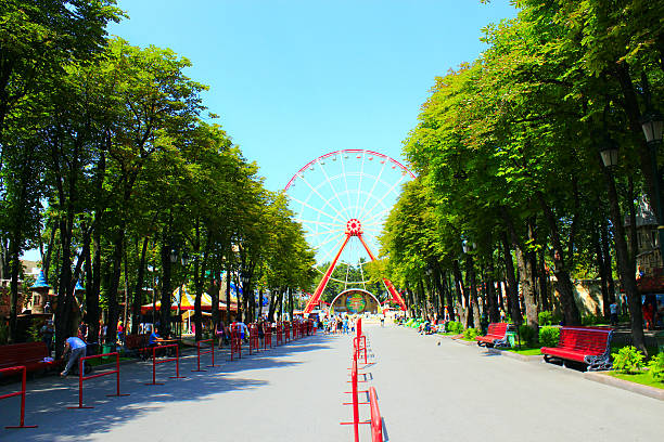 Kharkiv, Ukrainr - August 7, 2016: view to ferris wheel and people walk in Gorky park in Kharkiv