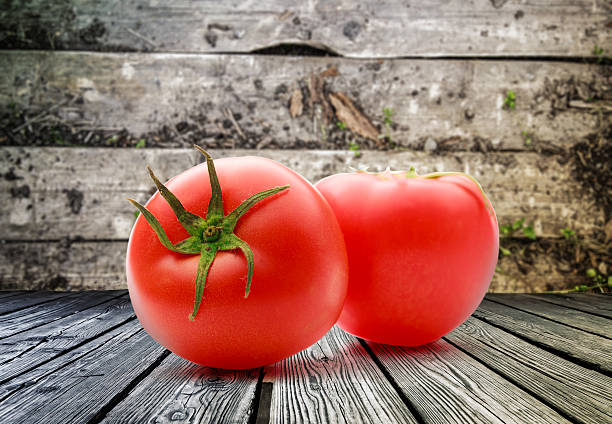 istock Two fresh tomatoes on wooden background 627721296