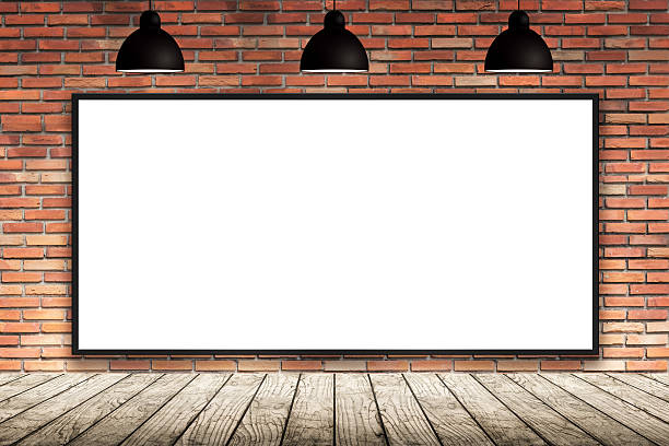Blank frame on brick wall with lamp. stock photo