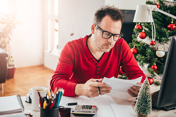 istock Man sitting at the office desk and reading letter 627723310