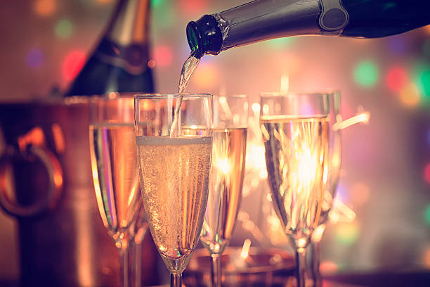 istock Pouring Champagne into Champagne Flutes 627723810