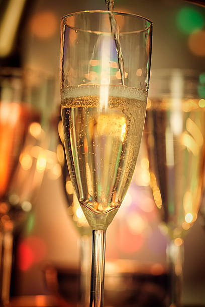 istock Pouring Champagne into Champagne Flutes 627723924