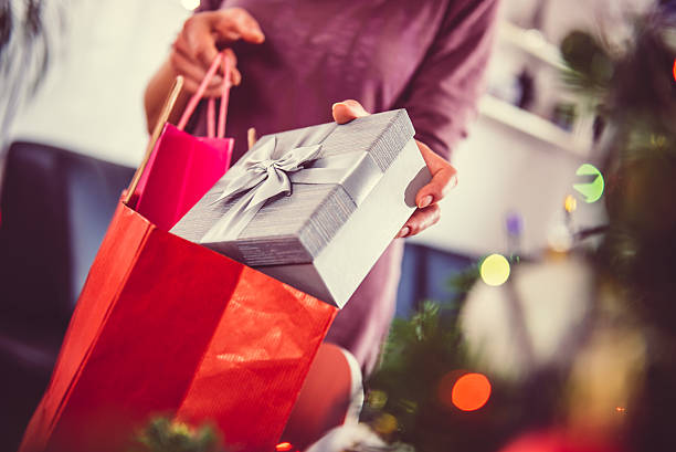 istock Woman taking out present from a shopping bag 627724122