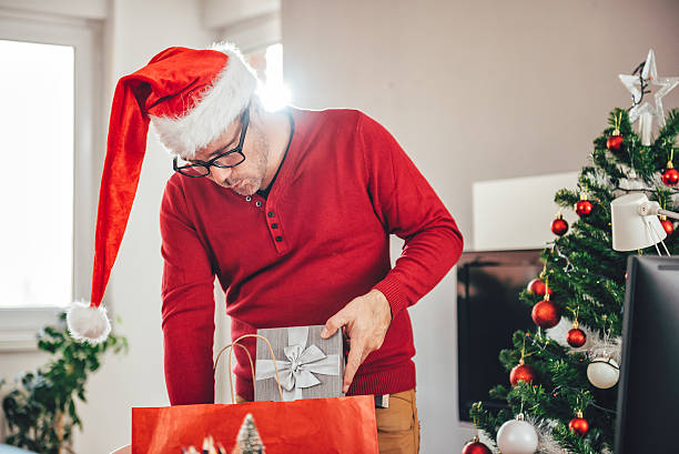 istock Man taking out present from a shopping bag 627724918