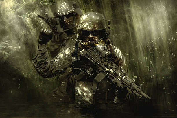 istock Green Berets soldiers in the jungle 627726362