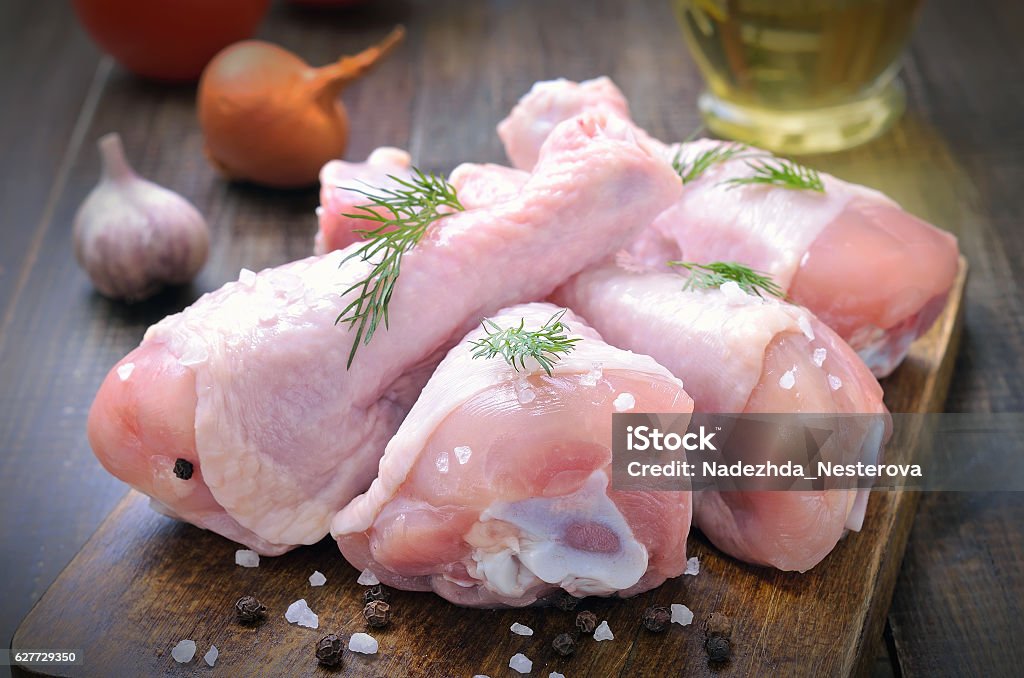 Raw chicken drumsticks Raw chicken drumsticks and spices on wooden cutting board Chicken Meat Stock Photo
