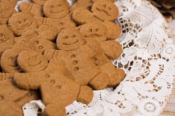 istock Many Christmas smiling  gingerbread men on white lace 627740042